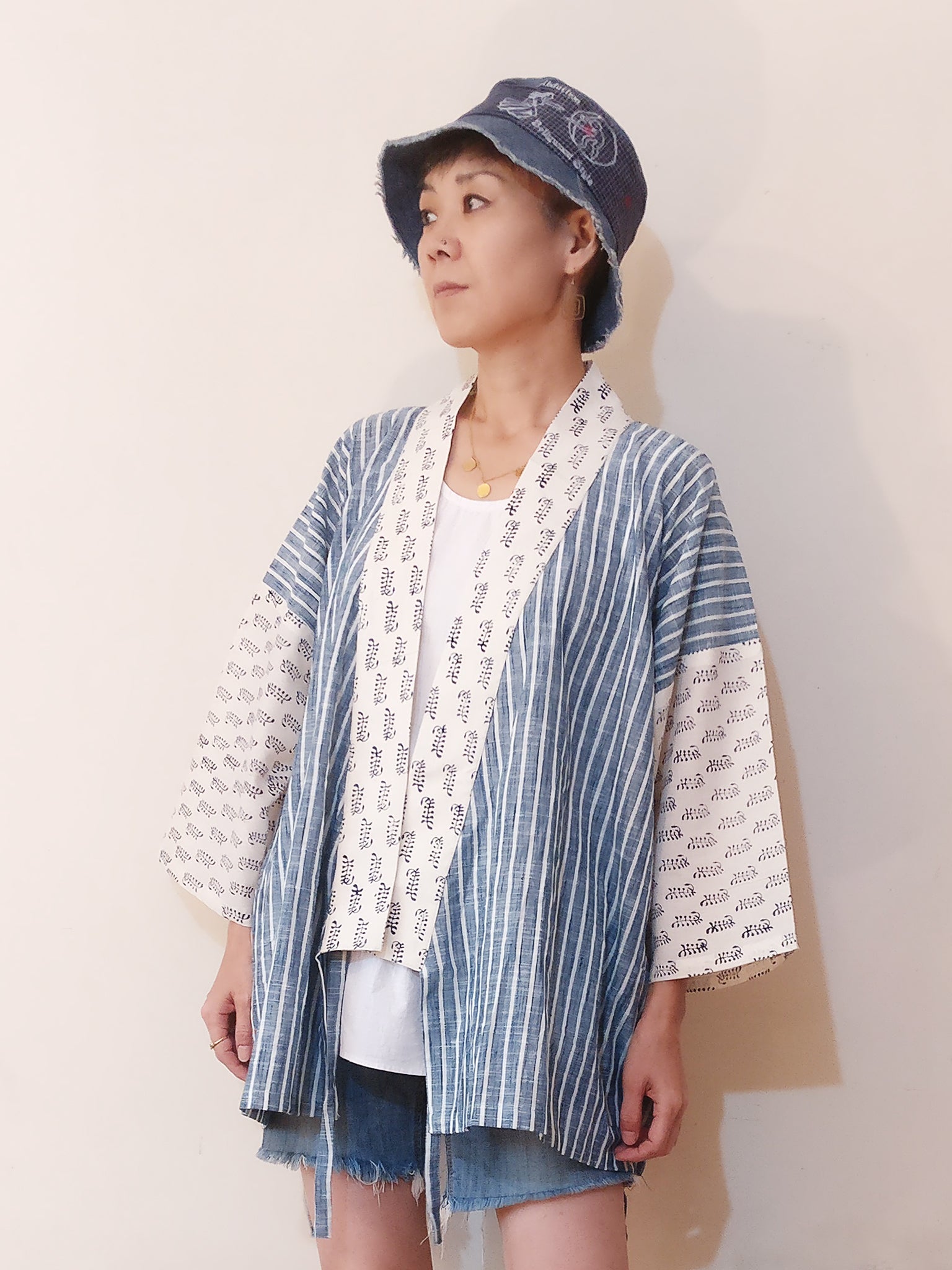 Kimono Jacket with a handloom cotton stripe with a delicate Mul Mul white (and blue) cotton print. Very very comfy, light, chic and calming. Buy online. With the strings open.