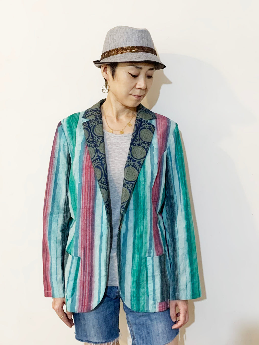 An Indian unique light blazer jacket made from a beautiful stripe printed cotton fabric, combined with a plant-print navy green collar. Absolutely gorgeous fabric combination. Shop online India!